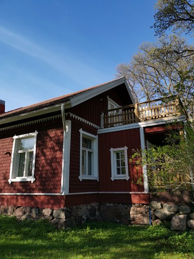 The charming red shingle-covered house from the 19th century